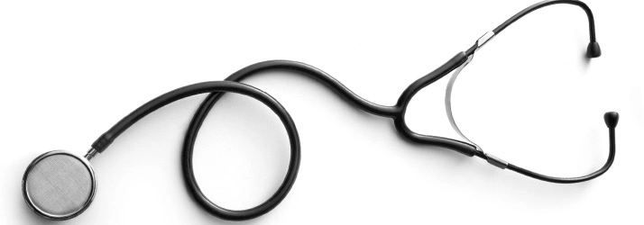 Black stethoscope with a coiled tube lying on a white background