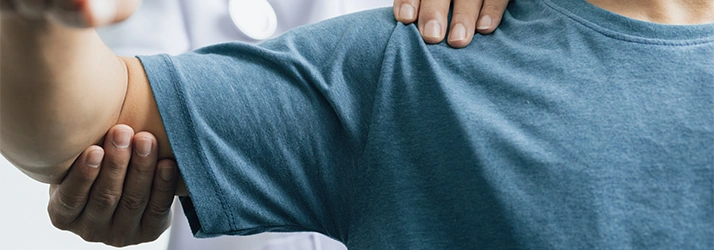 Close-up of a healthcare professional performing a shoulder examination